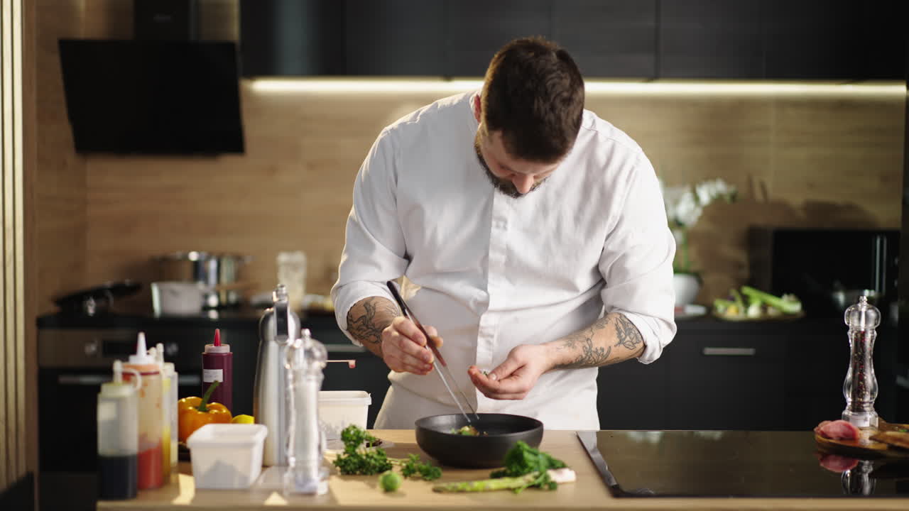 Professional Chef Plating a Dish in a Modern Kitchen
