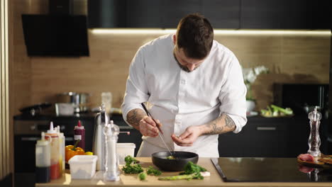 professional chef plating a dish in a modern kitchen
