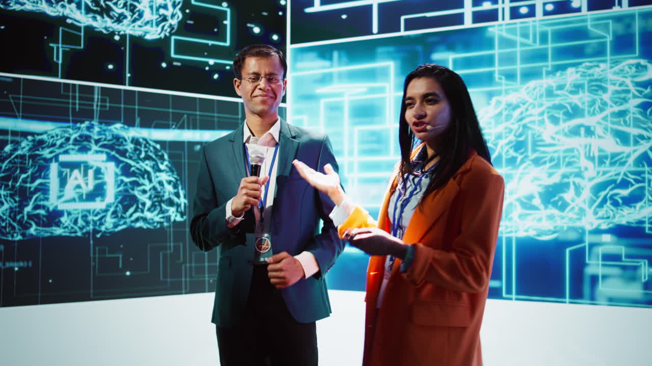 Presenter and guest talking at AI summit exploring latest tech developments