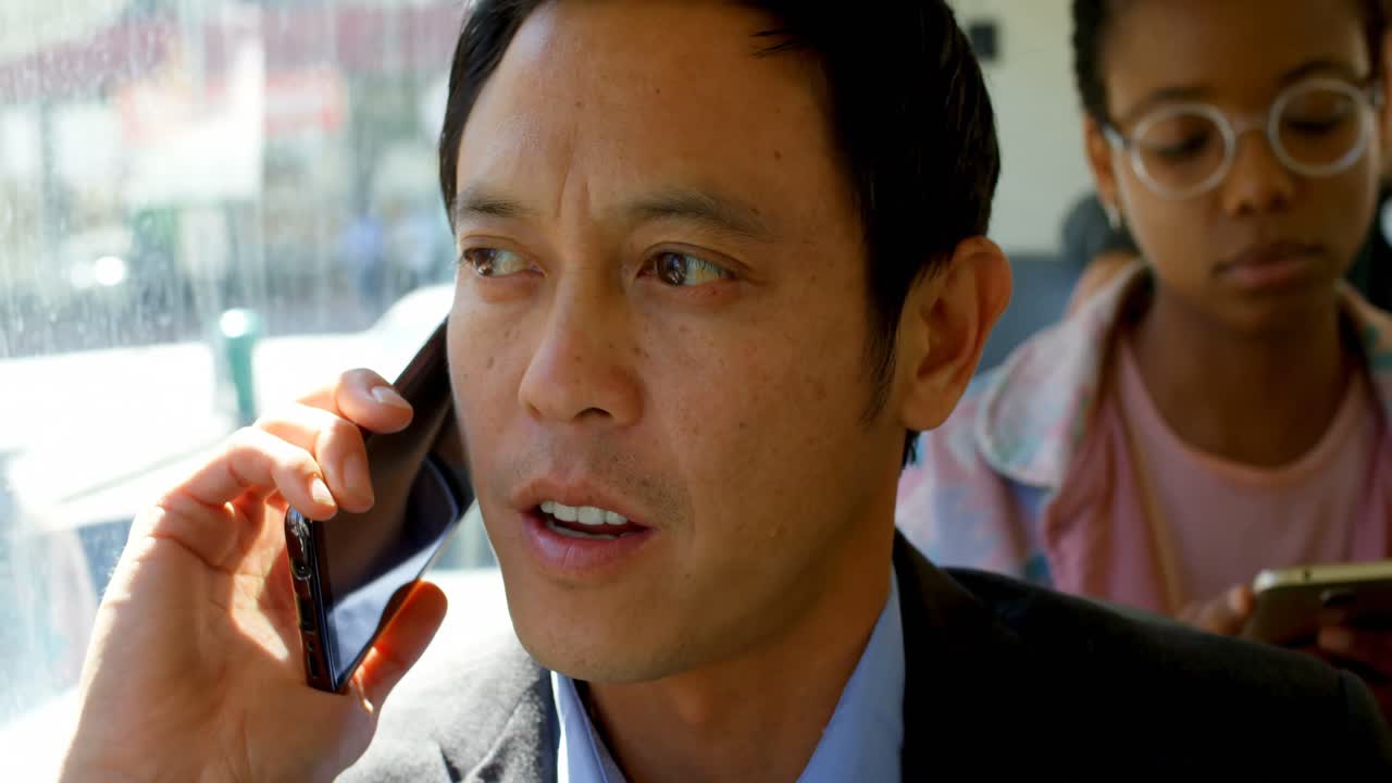 4k 버스에서 여행하는 동안 휴대 전화로 이야기하는 비즈니스 통근자