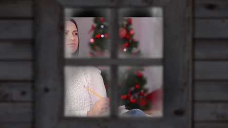 Animation-of-caucasian-woman-and-christmas-tree-over-window