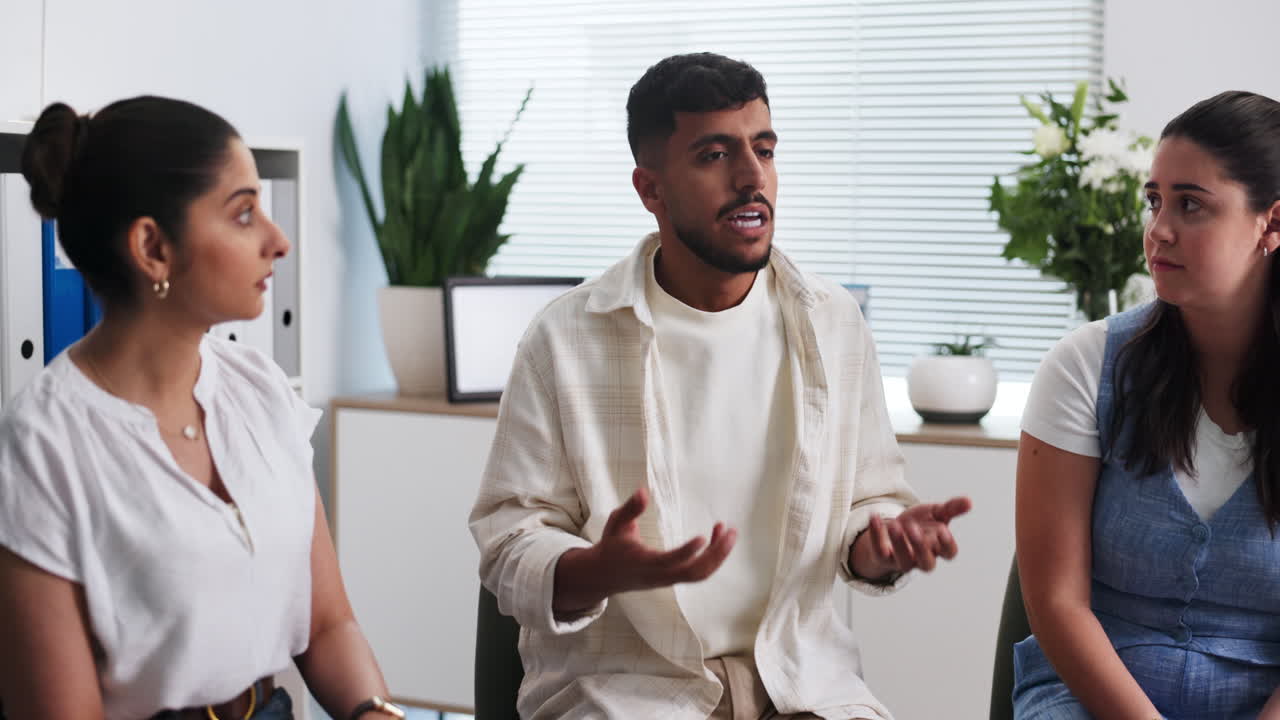 Young Man Shares His Thoughts During a Group Discussion
