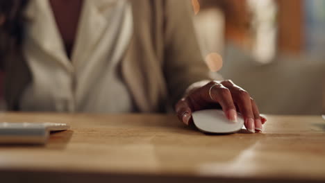 close-up of woman's hand using computer mouse