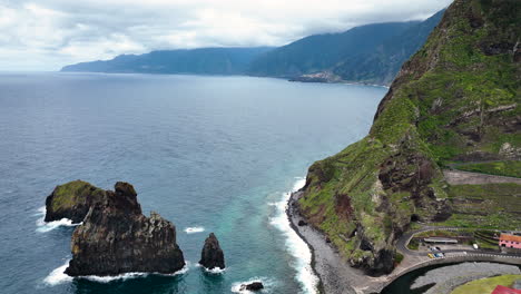 Aerial-over-rugged-lava-rock-formations-on-coast,-Porto-Moniz,-Madeira