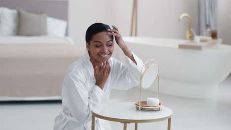 woman applying skincare cream in a luxurious bathroom