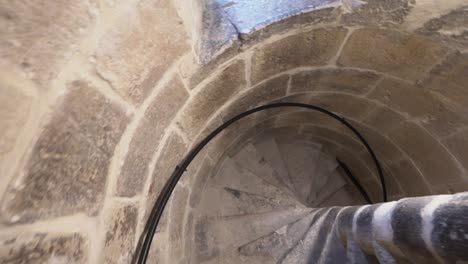 Top-down-descent-of-rustic-concrete-spiral-stairs