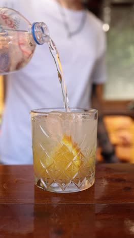 pouring soda water cocktail