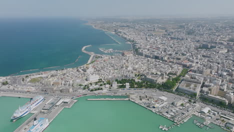 super wide aerial footage showing the peninsula of old town bari, italy during the bright day