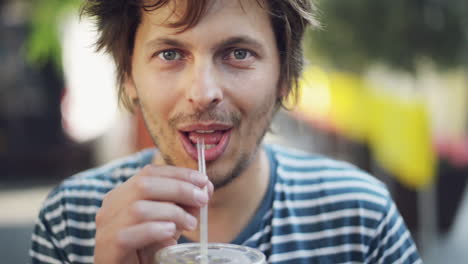 attractive-man-portrait-in-city-looking-at-camera