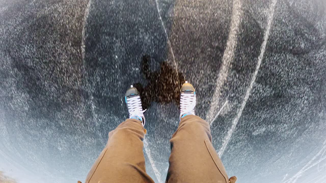 POV shot starts with a skater’s feet, then lifts to reveal a woman skating ahead