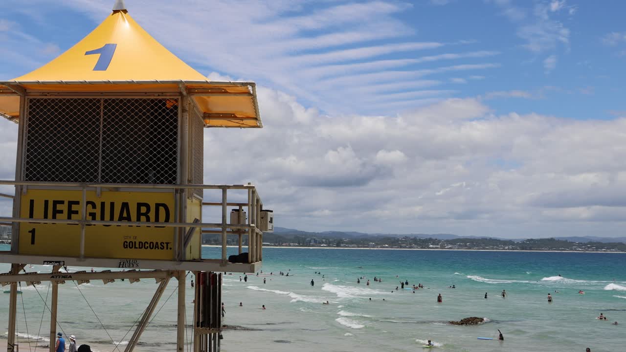 Crowded beach scene with active lifeguard station