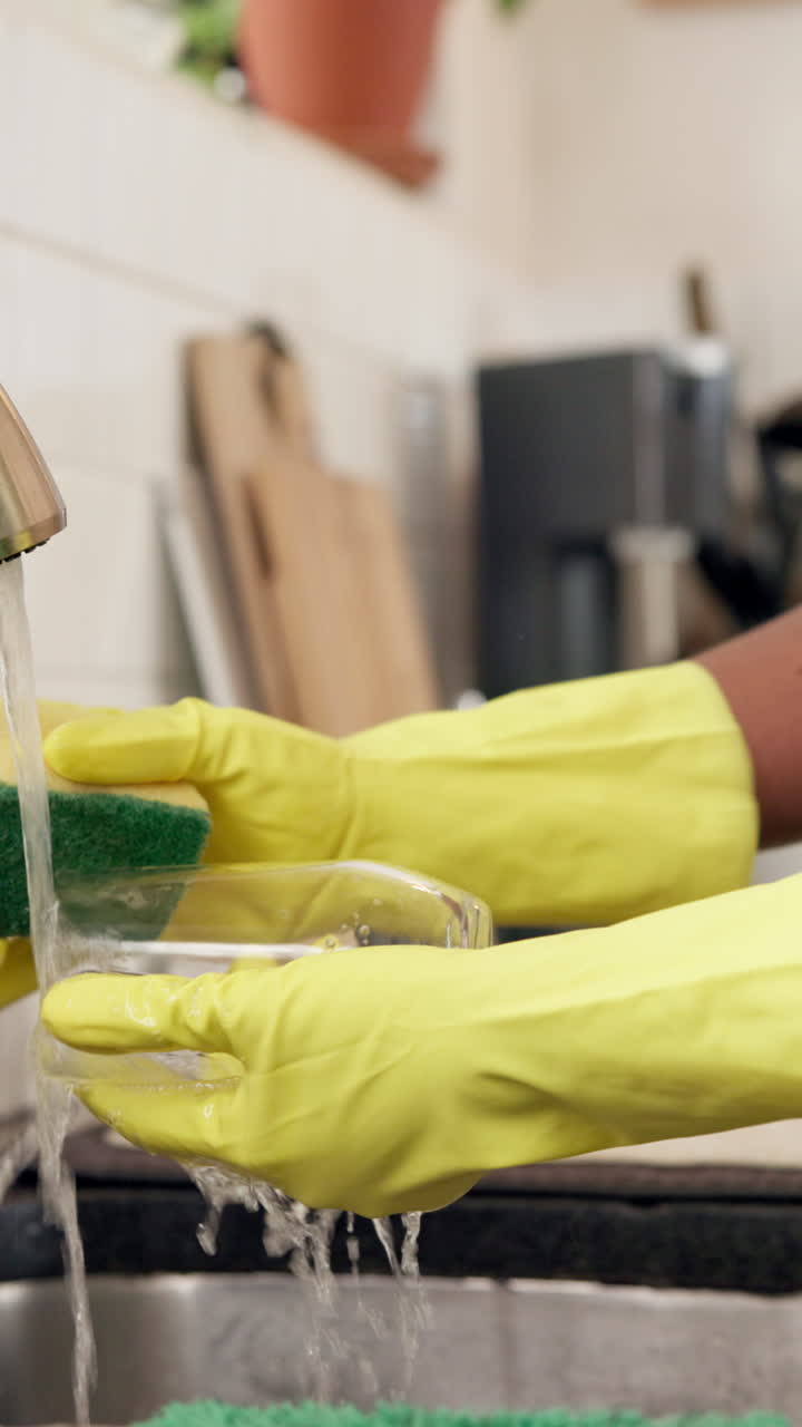 Washing dishes with rubber gloves