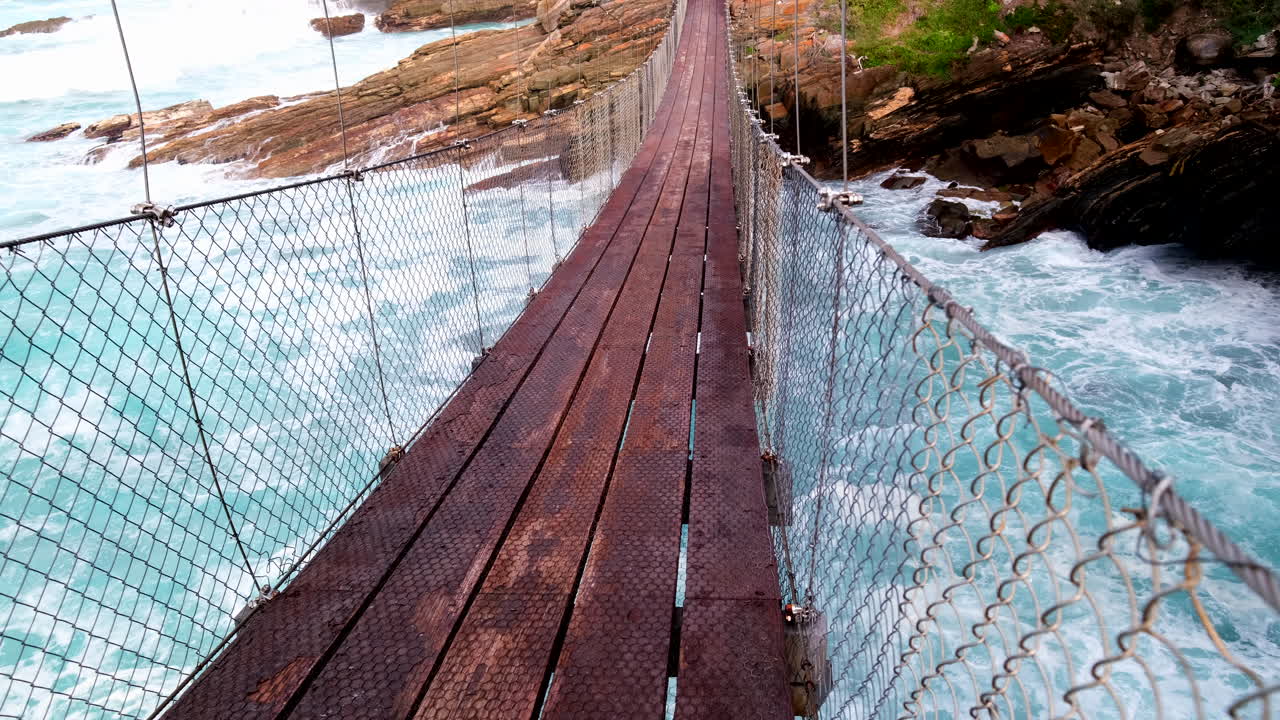 POV shot of waves running under Storms River suspension bridge, Tsitsikamma