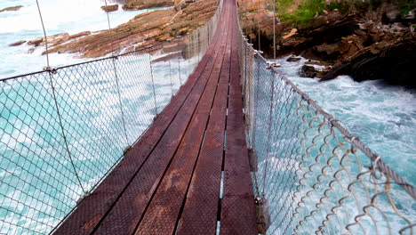 pov shot of waves running under storms river suspension bridge, tsitsikamma