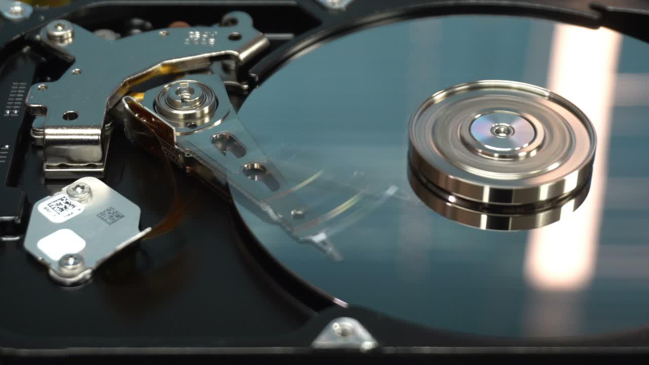 4K Close up of a hard disk drive reading and writing data and internal structure for computer PC or Server and Cloud technology.