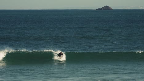 surfer catching waves near portugal coast, handheld view