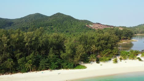 thailand coast with moored boats near the sandy beach