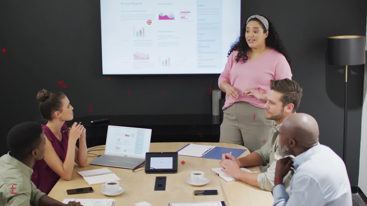 Marketing lead pointing at screen and explaining financial charts updating to inform team decisions