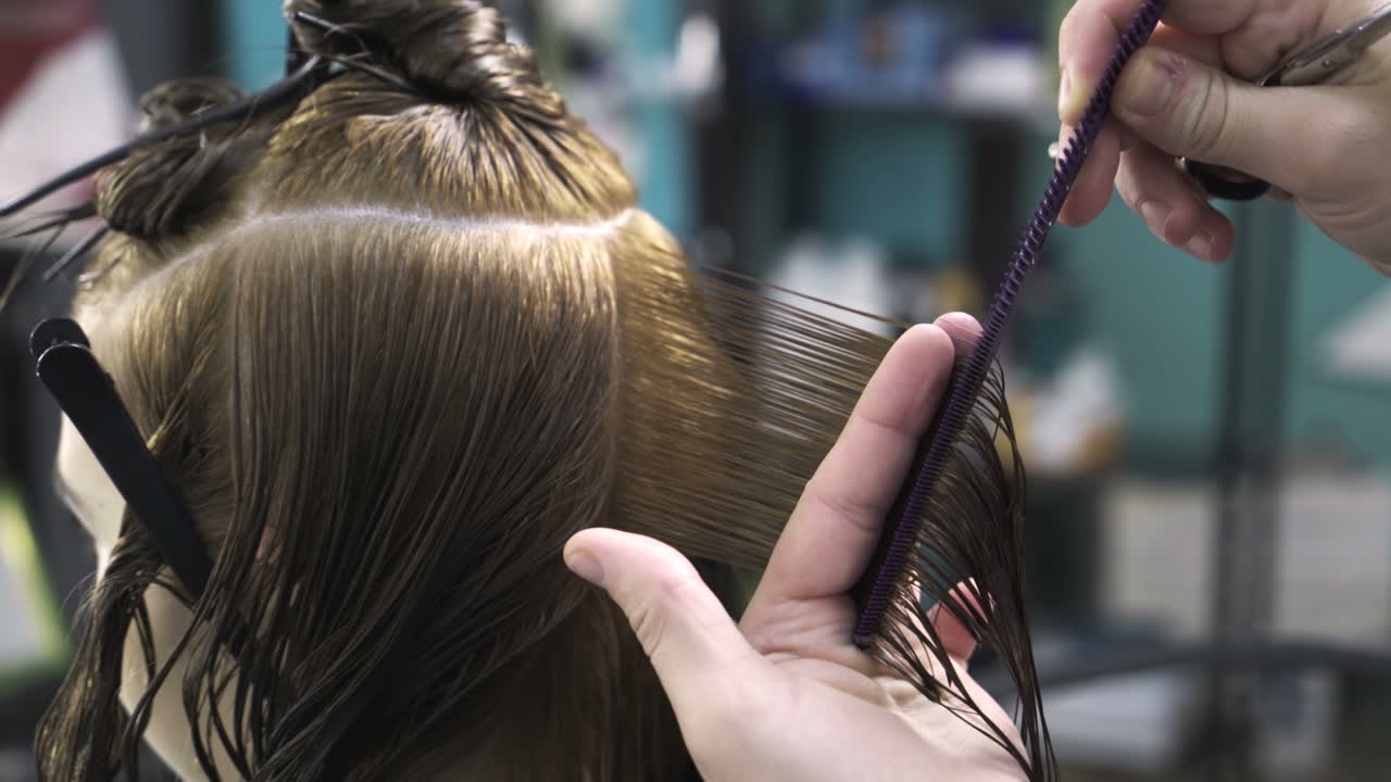 Professional hairdresser cutting hair. Young woman and hairdresser making styling hair at beaty salon