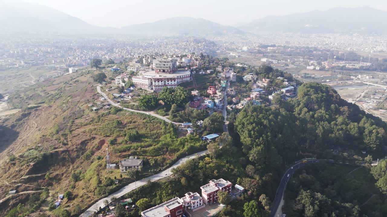 Discover the peaceful Buddhist monastery in Kathmandu Valley, Nepal. Drone footage captures its architecture, surrounding mountains, and spiritual atmosphere, highlighting Nepal’s rich culture