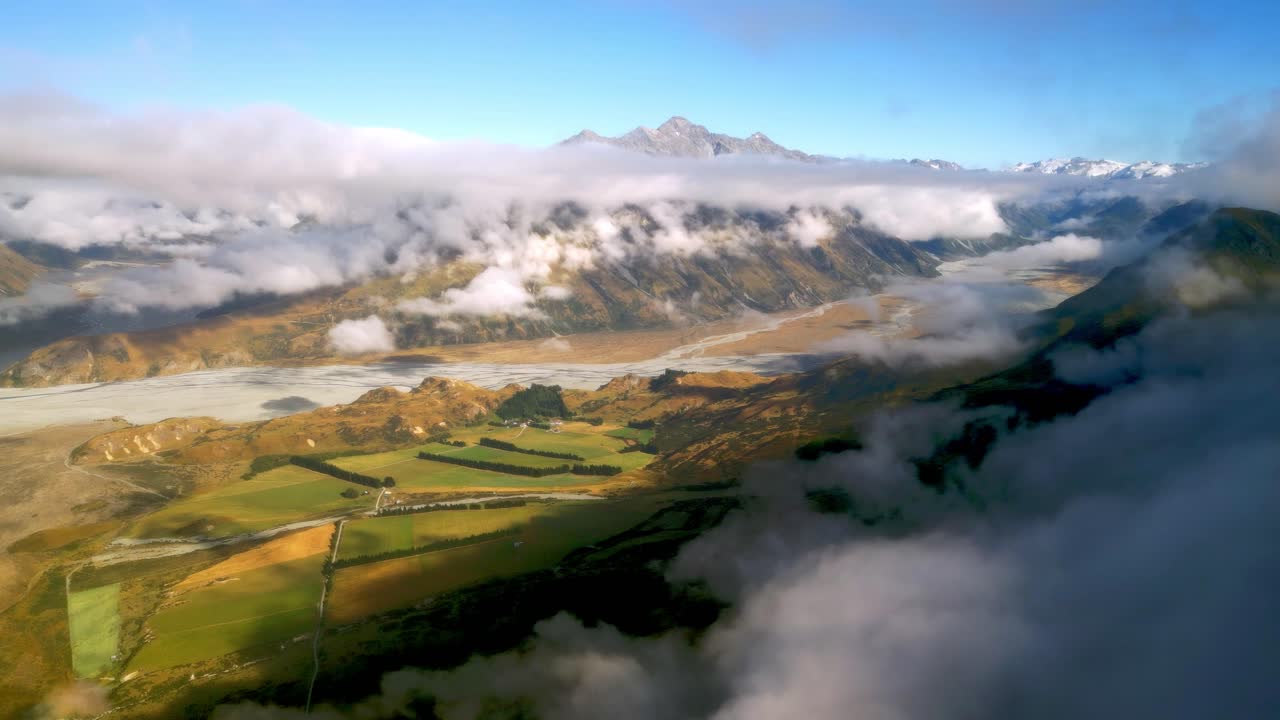 Aerial view of the Rangitata River and the New Zealand Southern Alps shrouded in cloud.