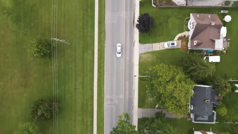 drone top down bird's eye view of suburban neighborhood next to green maintained park