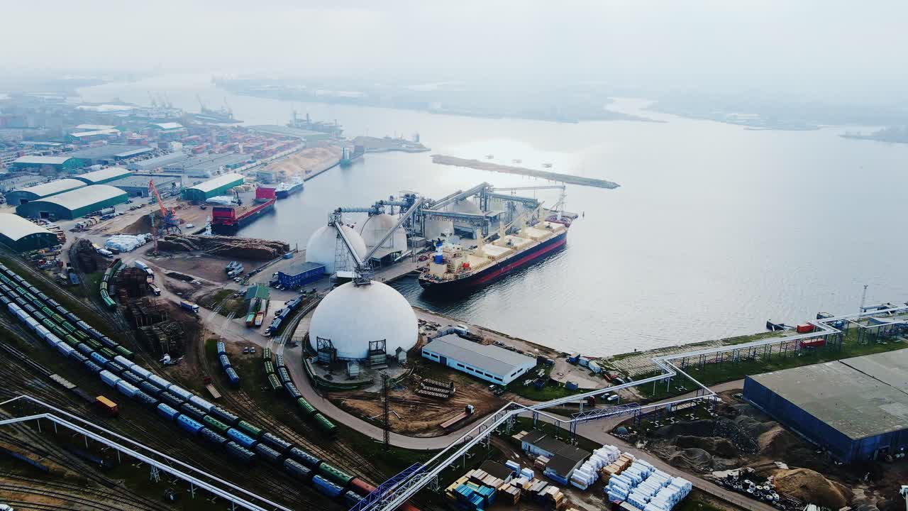 Industrial landscape of Riga Port showing shipping terminals, tanks and trains