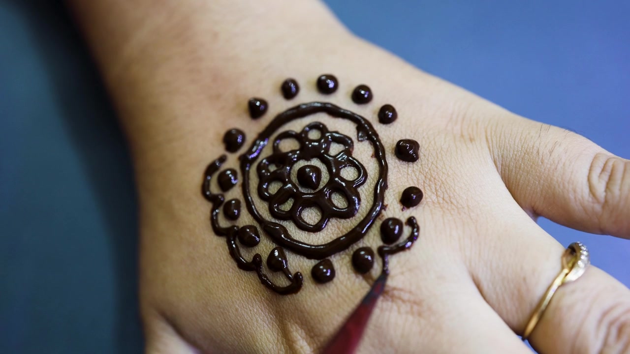Traditional Indian Henna Art Being Applied To Woman Hand