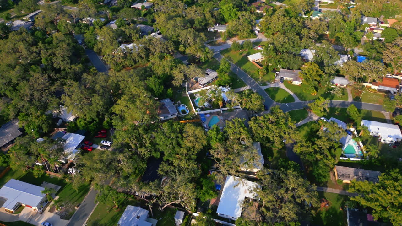 Drone high angle overview dolly of suburban area of Tampa with greenery, homes, and the Hillsborough River