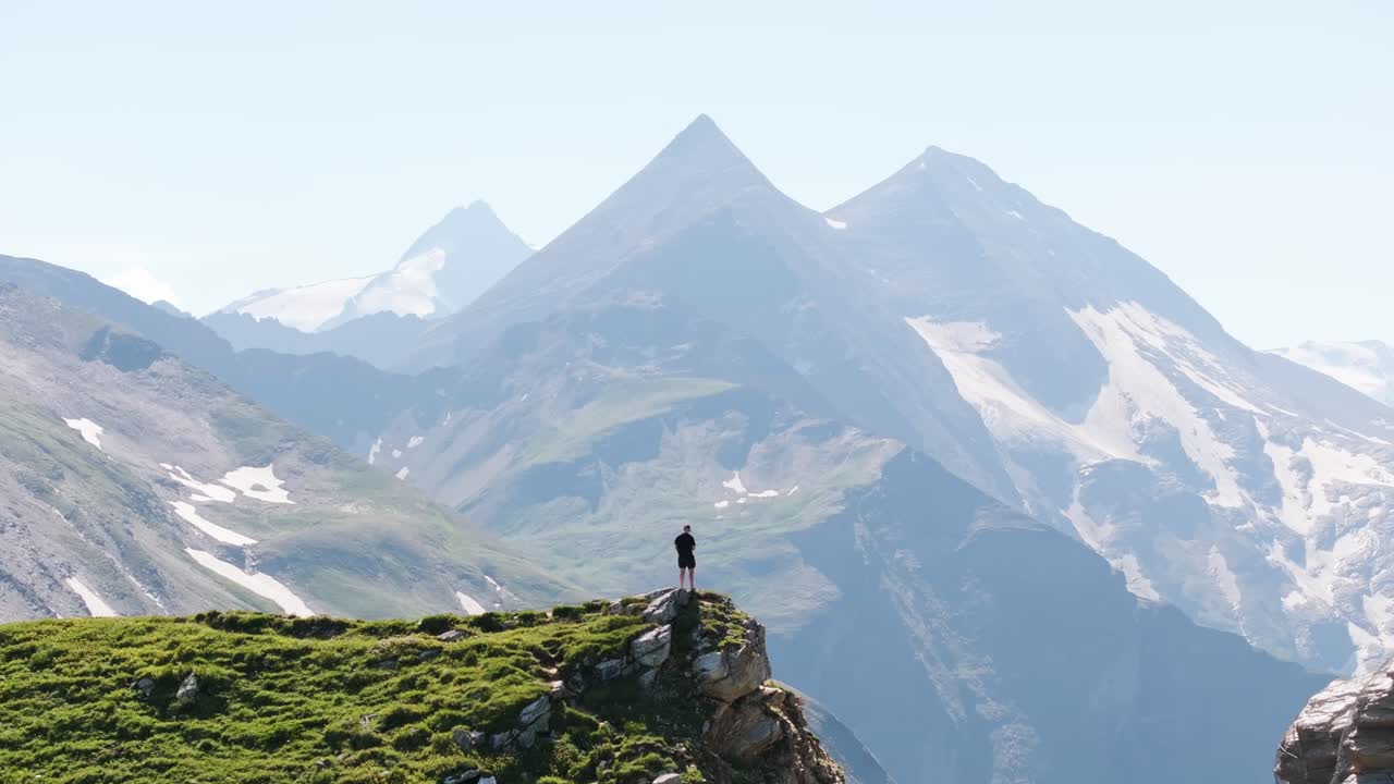Dramatic scenery unfolds as lone hiker overlooks Grossglockner High Alpine Road