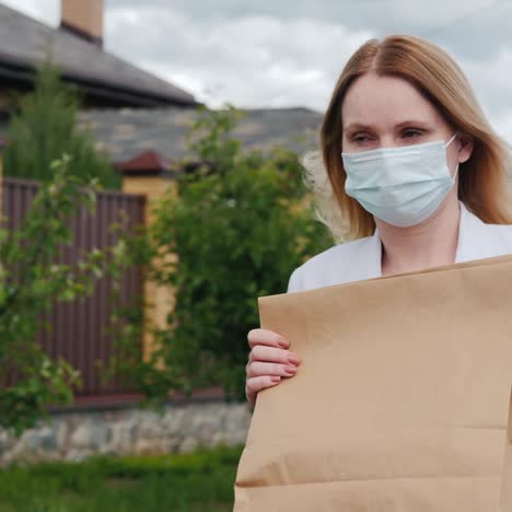 Masked-Woman-Carries-Groceries-To-Her-Home-1