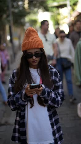 woman using a smartphone on a city street