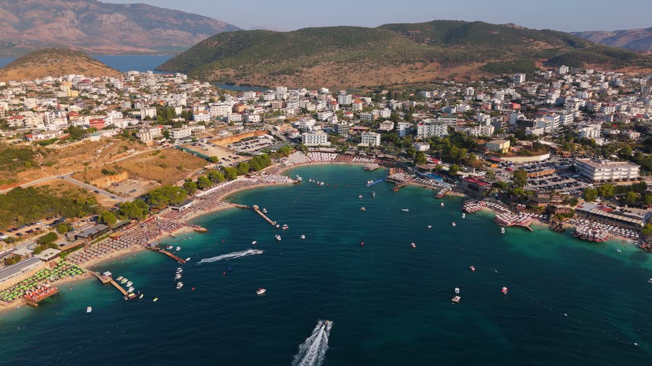 Ksamil, albania with tourists enjoying the beach and clear turquoise waters, aerial view