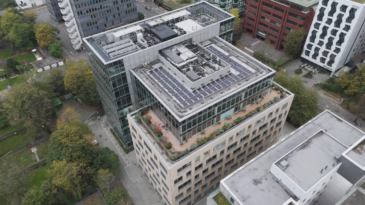 Aerial View of a Modern Building with Solar Panels and Green Roof in London