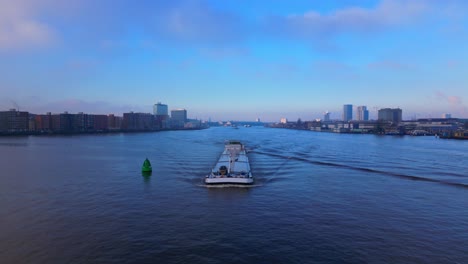 aerial tracking shot of tanker ship coming from north sea canal in amsterdam