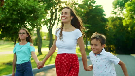 Cheerful-family-meeting-father-on-street.-Smiling-woman-hugging-man-outside