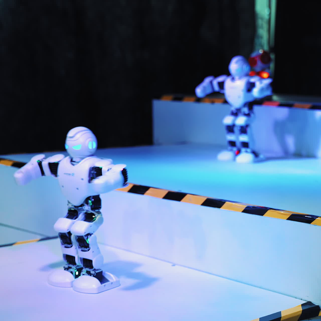 Humanoid robot dance. Group of cute robots dancing. Close up of smart robot dance show. Dancing robot performance. Robotic dance party. Smart robotic technology