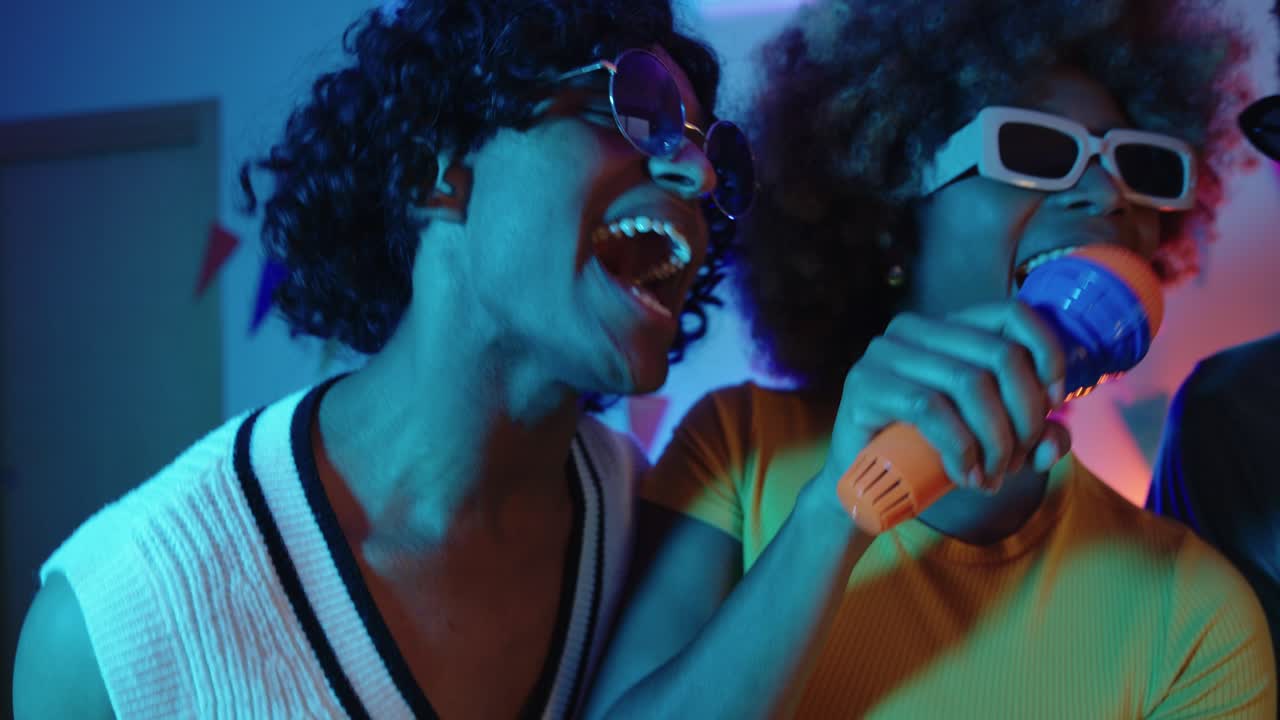 Friends singing karaoke at a party