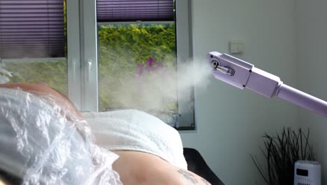facial steam machine in action during a skincare treatment in a spa