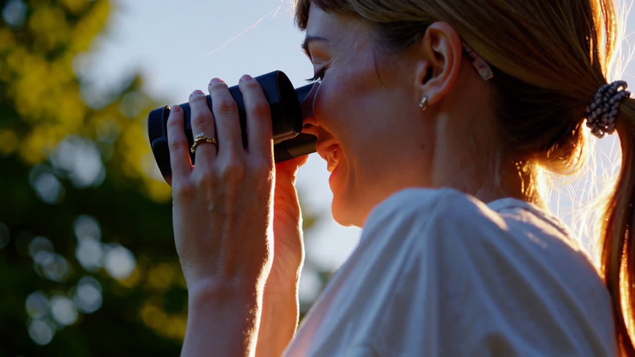 Woman with binoculars in a park