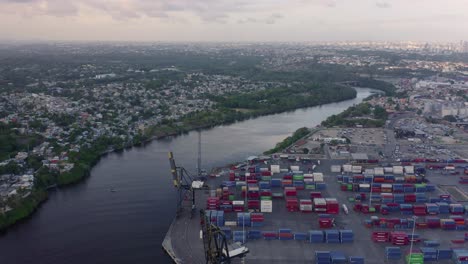 aerial view over channel of haina commercial port and logistic center