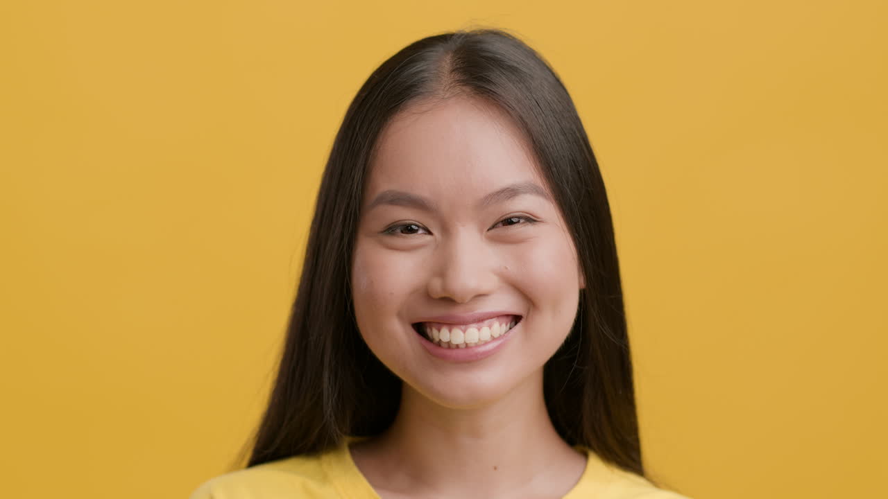 Happy Young Asian Woman Smiling and Laughing