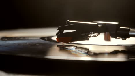 close-up of using an antiquarian vinyl record player. turntable player,dropping stylus needle on vinyl record playing