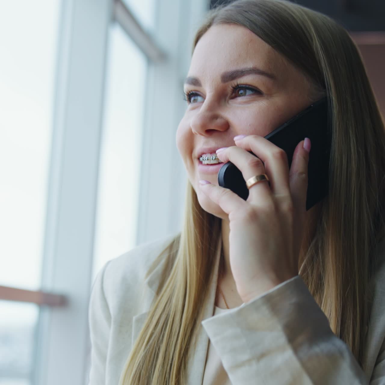 Young lady starting conversation on the phone. Woman speaking on the phone and drinking tea. Close up