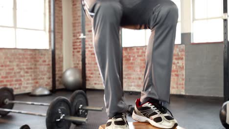 fit man doing box jumps