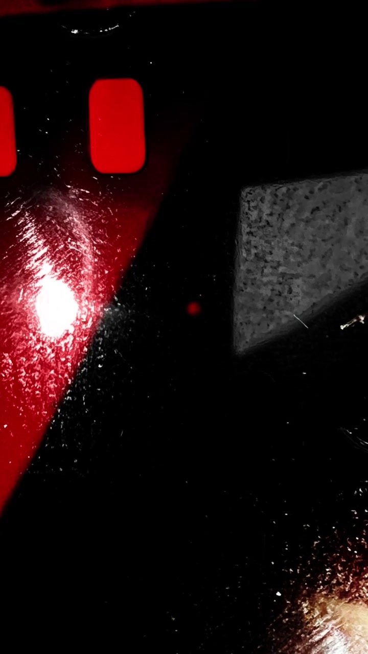 Abstract Close-up of Red and Black Textured Surface with Light Reflection