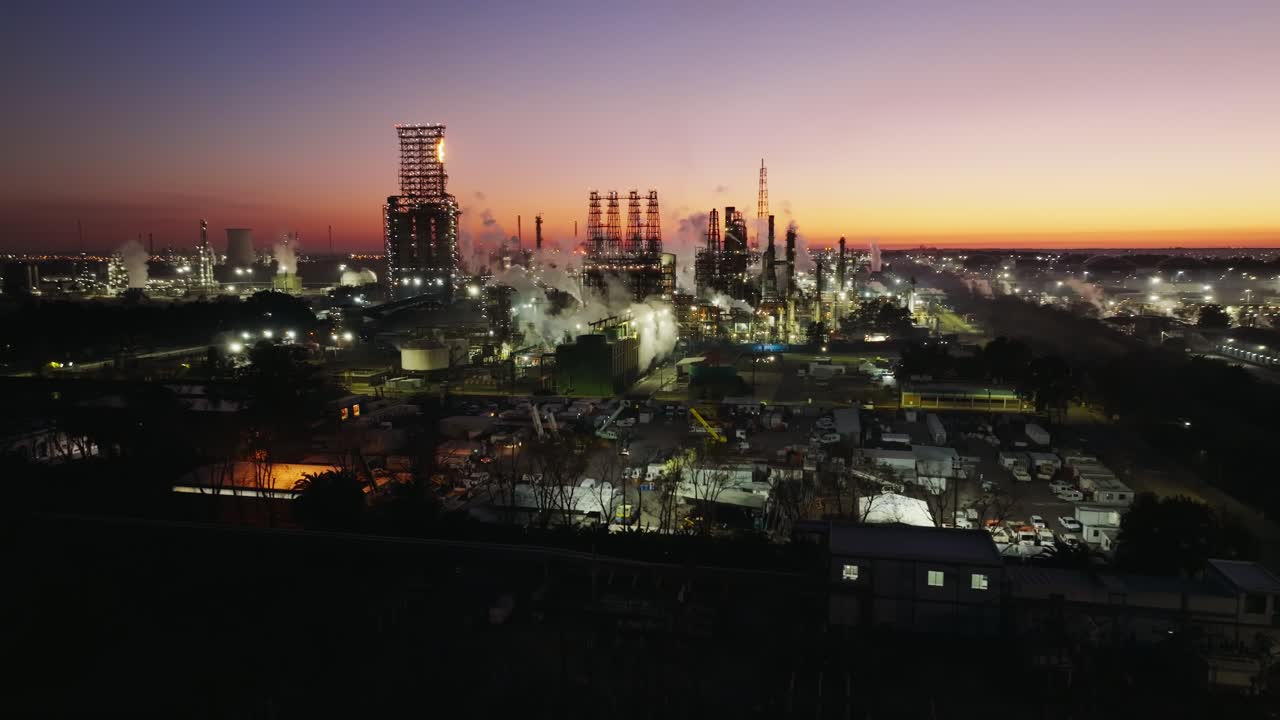 Dusk view of oil refinery and energy plant, capturing industrial activity