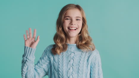 teenage caucasian girl greeting and looking at the camera.