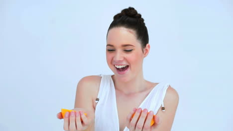 Attractive-woman-holding-slices-of-orange