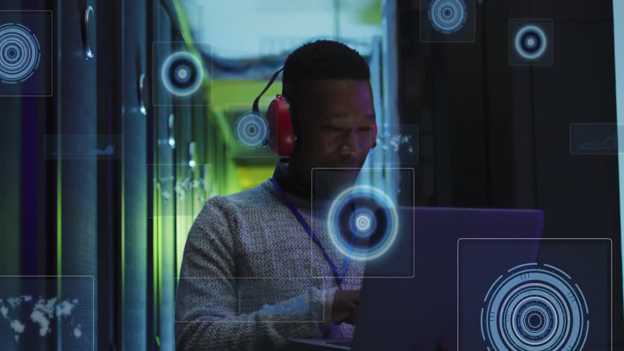 Animation of processing circles over african american man working in server room